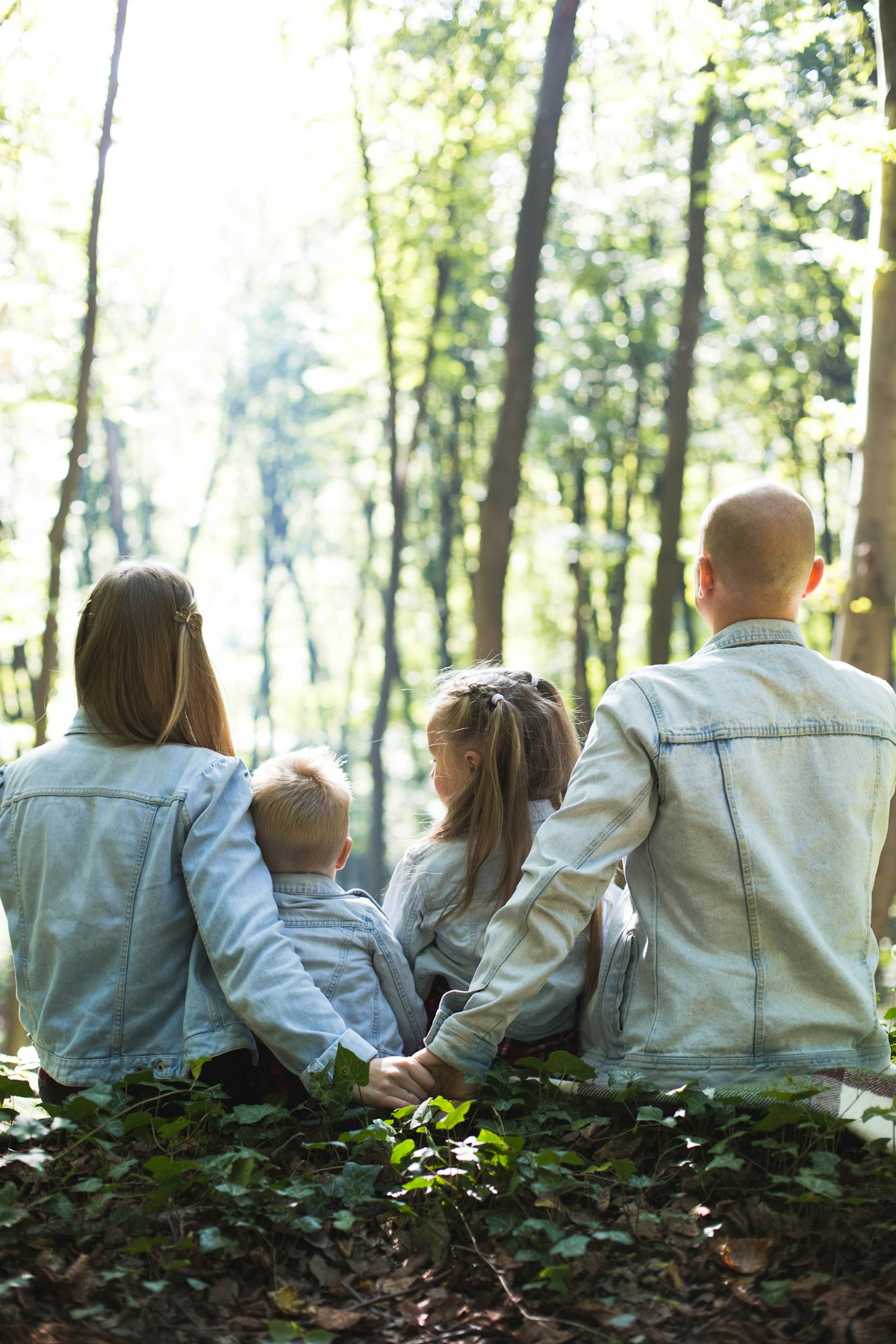 Family sitting together outdoors, protected by health and life coverage